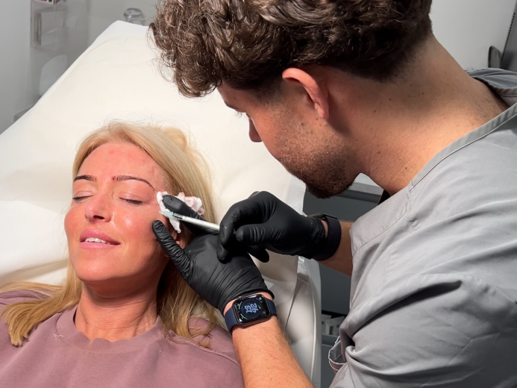 Aesthetic practitioner performing a non-surgical facelift with dermal fillers and Botox at DermaGlo Skin Clinic.